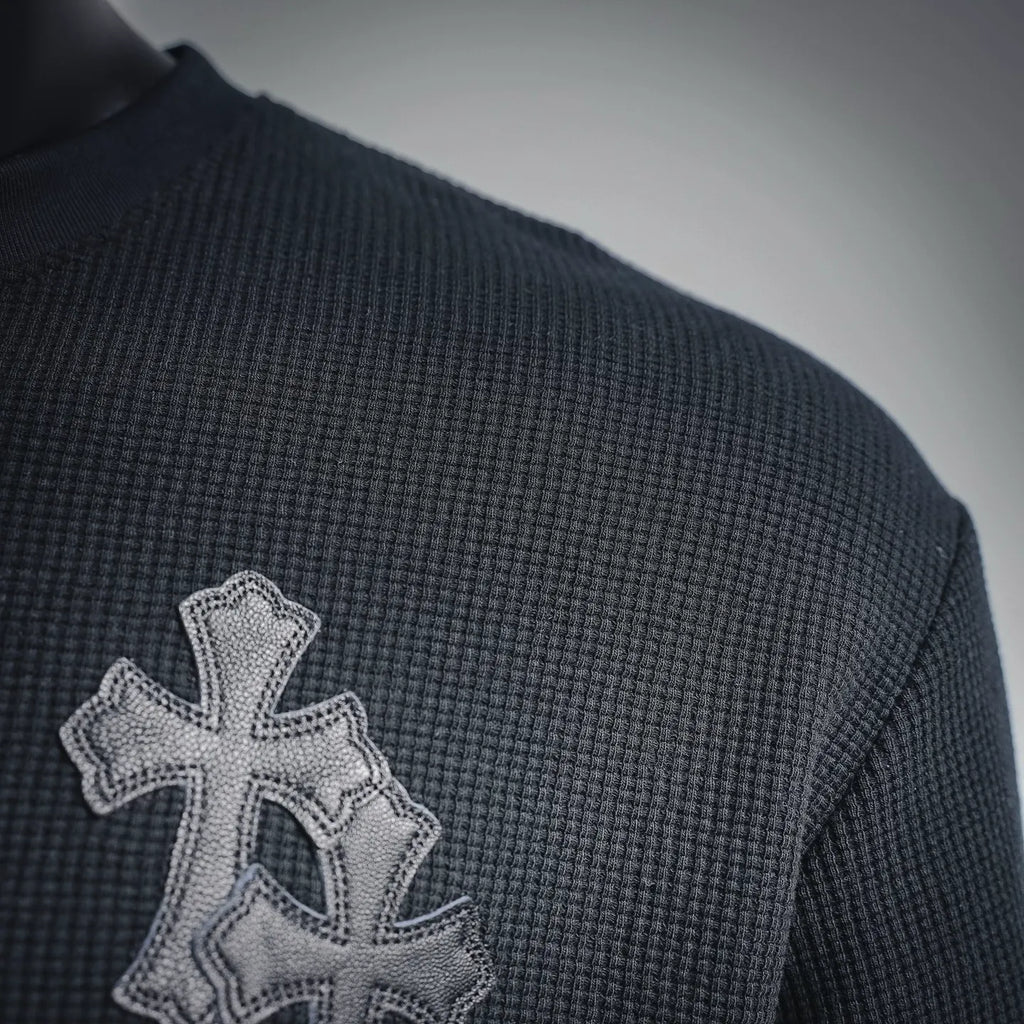 Dark henley with embroidered silver cross patch on the left shoulder
