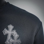 Dark henley with embroidered silver cross patch on the left shoulder