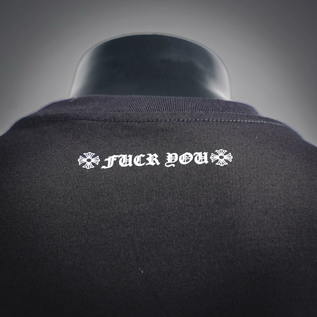 Black long-sleeve T-shirt back neck with white logo text