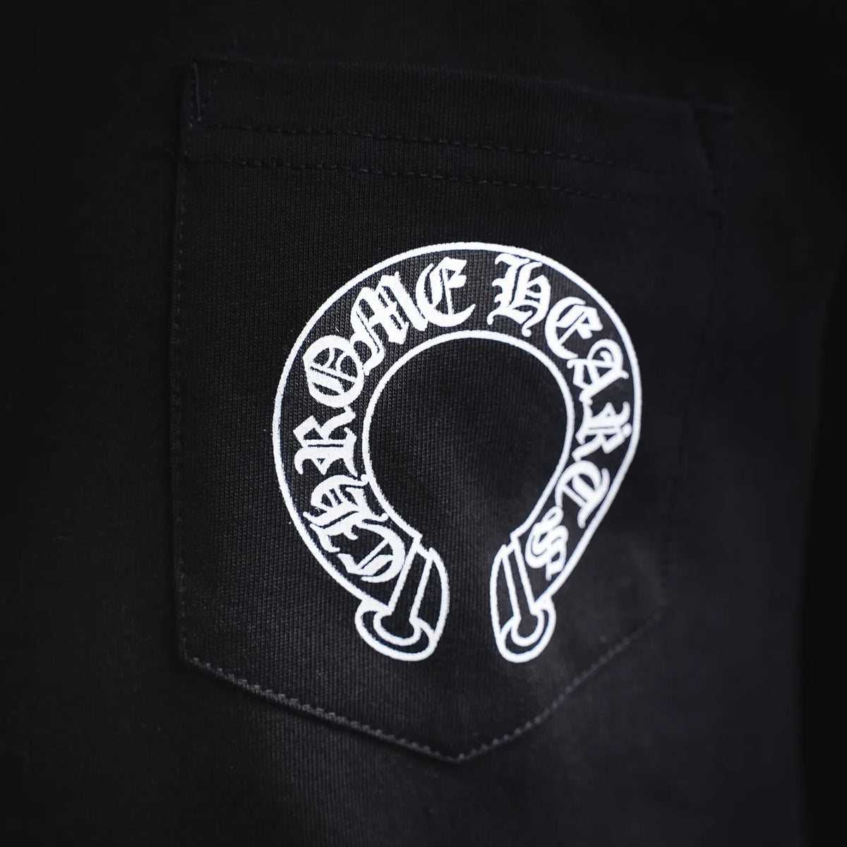 Black long-sleeve T-shirt chest pocket with white circular logo