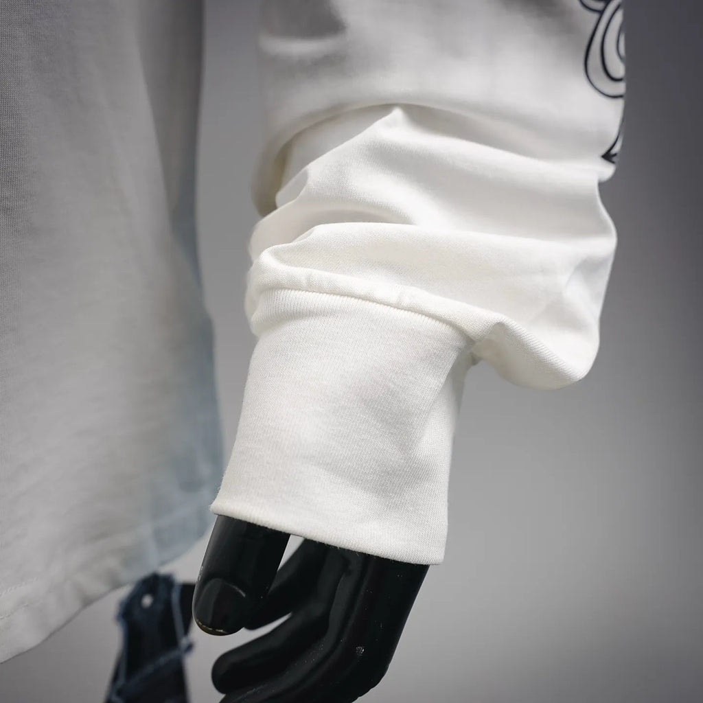 White long-sleeve T-shirt sleeve cuff detail with stitched seam