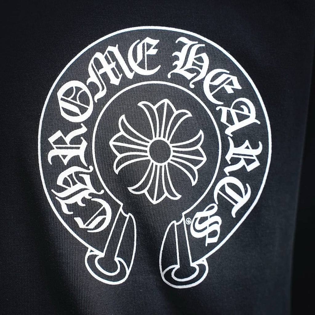 Black long-sleeve T-shirt with large white circular emblem graphic