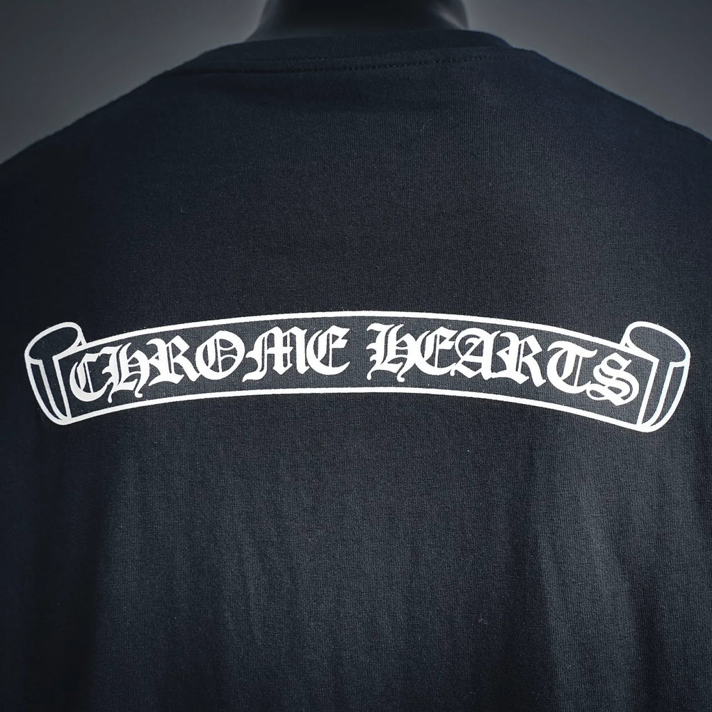 Dark long-sleeve shirt with large white Chrome Hearts back lettering.