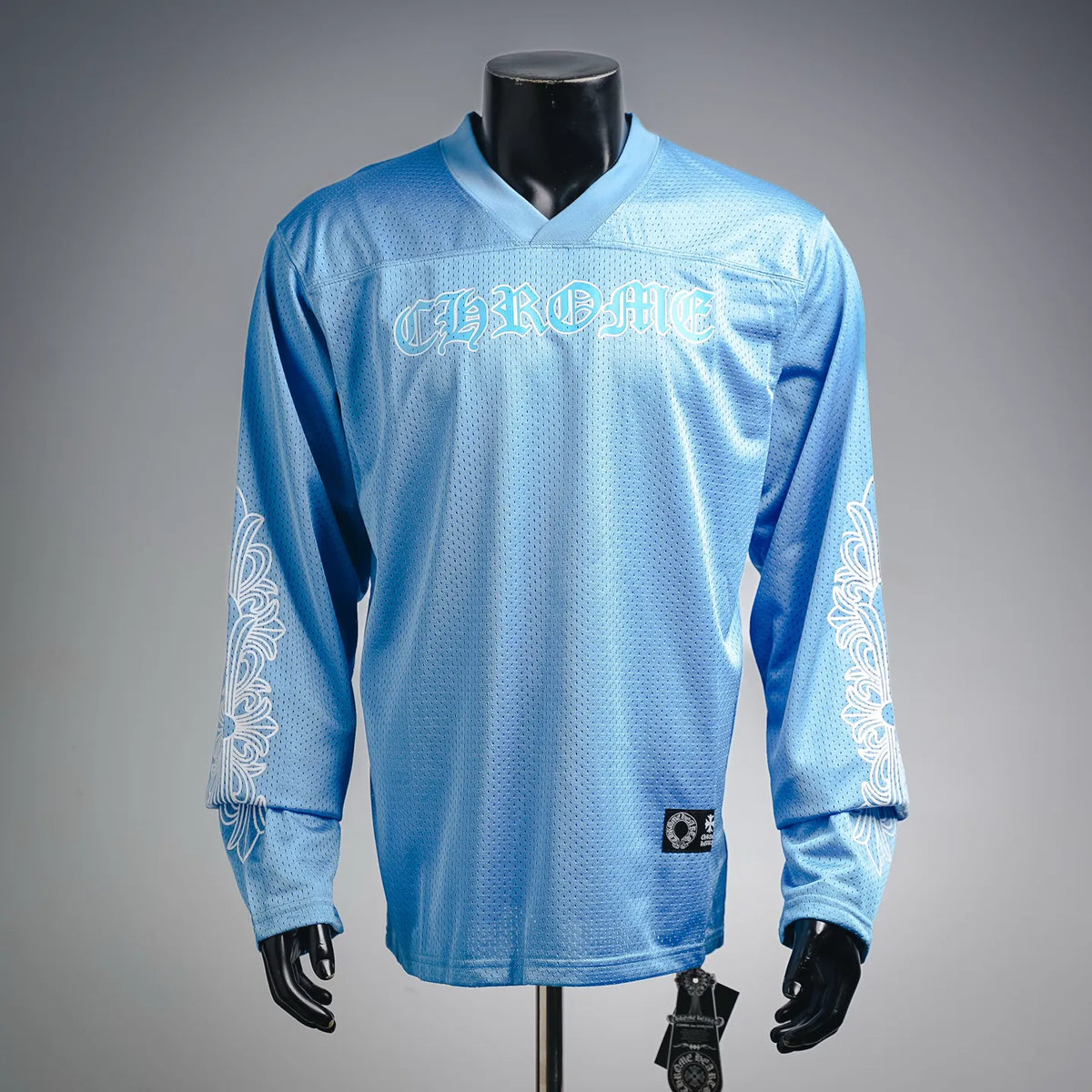 Light blue long-sleeve V-neck jersey with bold front graphic print and side detailing