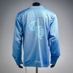 Light blue long-sleeve V-neck jersey shown from back with large center graphic