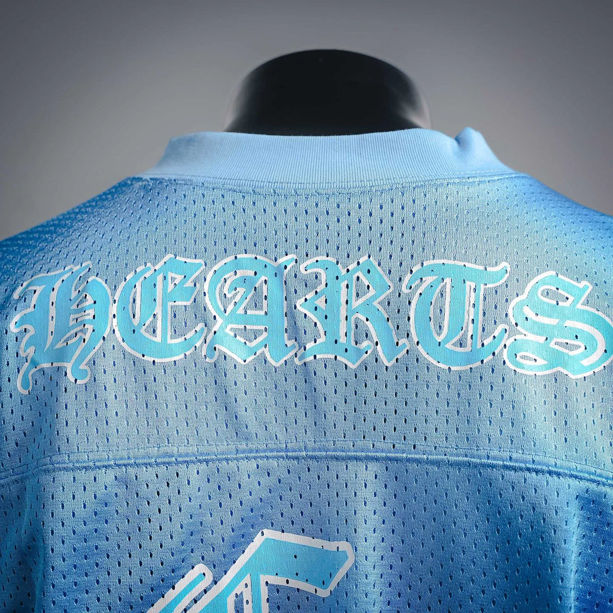 Light blue back of jersey with arched graphic lettering across the upper section