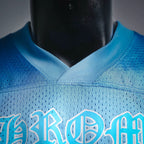 Close-up of light blue jersey neckline and lower front lettering graphic