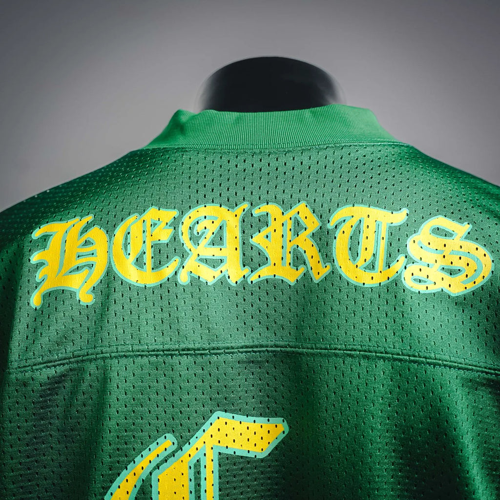 Green jersey back with large yellow stylized lettering across upper yoke