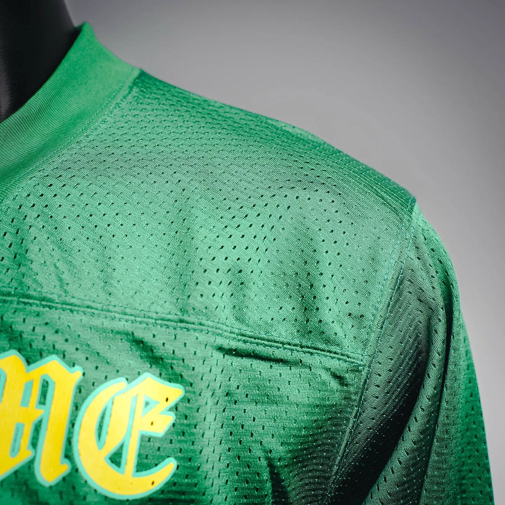 Green long-sleeve jersey with yellow left chest emblem and mesh texture