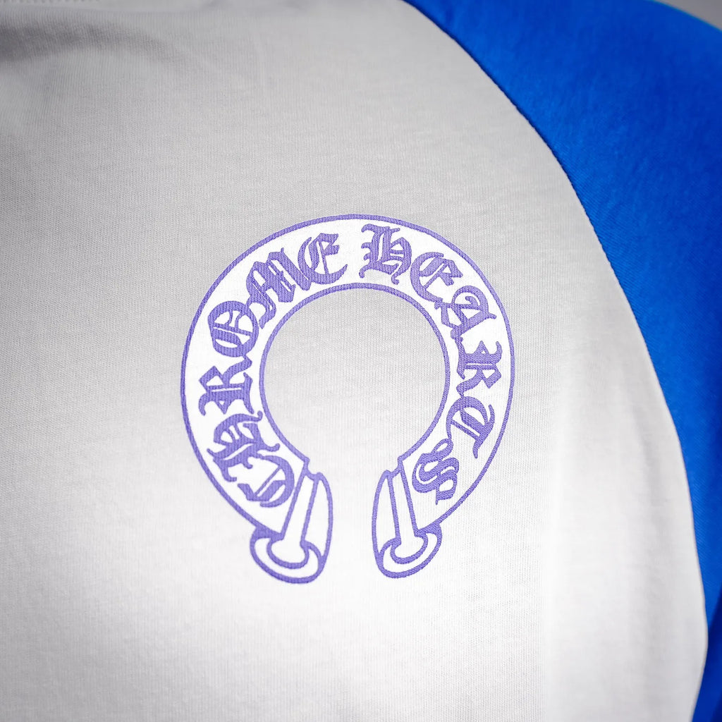 Long-sleeve raglan shirt close-up: purple circular crest logo on white chest