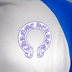 Long-sleeve raglan shirt close-up: purple circular crest logo on white chest