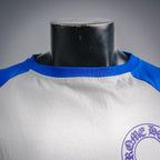 Long-sleeve raglan shirt with blue crew neckline band, partial crest logo