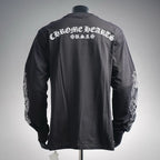 Long-sleeve dark T-shirt with large back text graphic and white sleeve emblem