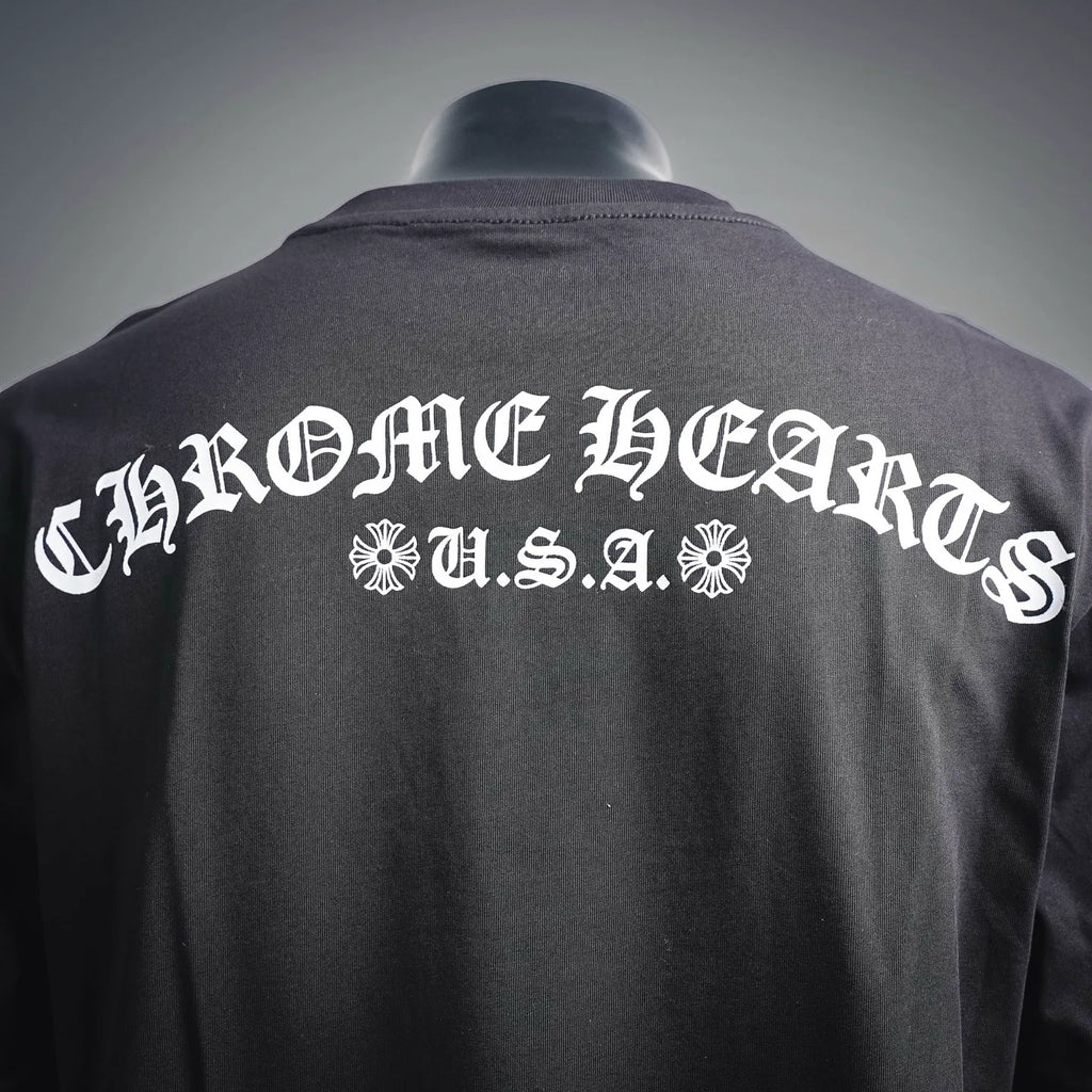 Back of dark long-sleeve T-shirt with large white U.S.A. text and ornamental emblem