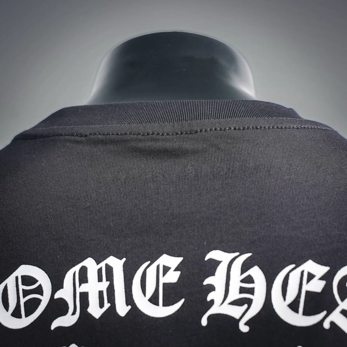 Dark long-sleeve T-shirt collar with stitched neckline and partial white back lettering