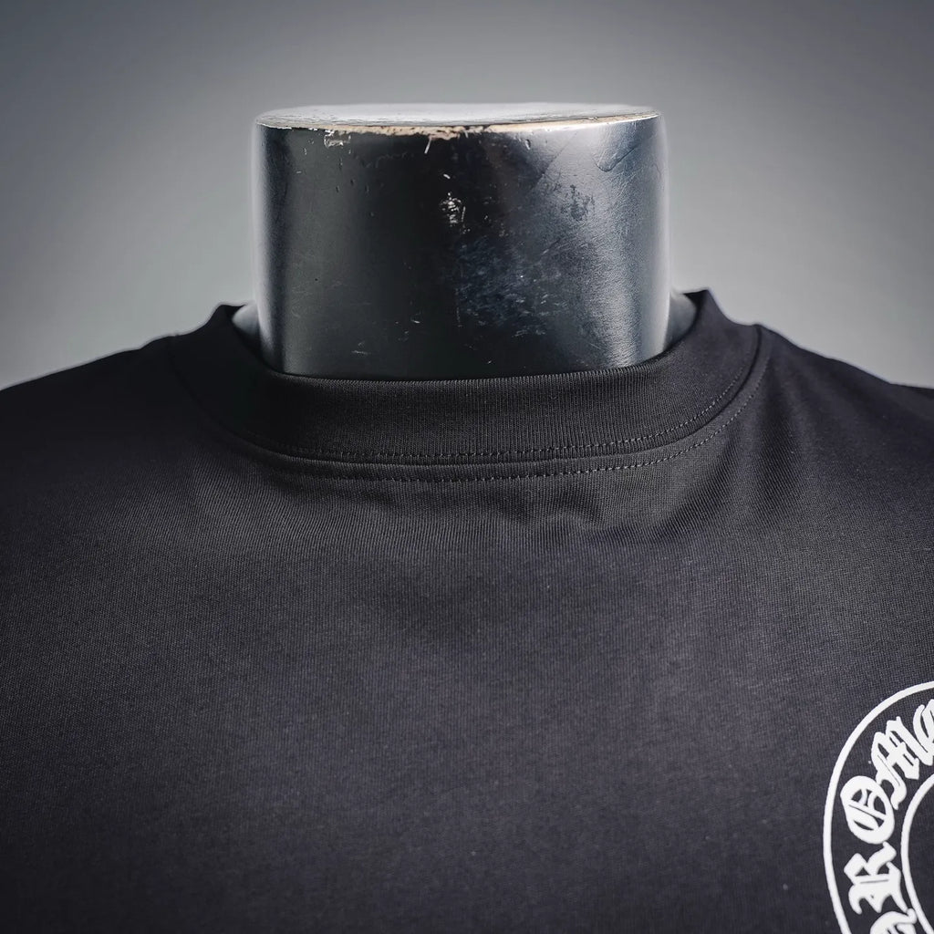 Dark long-sleeve T-shirt neckline and small white chest emblem