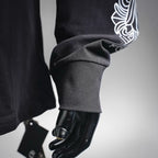 Dark long-sleeve T-shirt sleeve with white decorative cuff graphic
