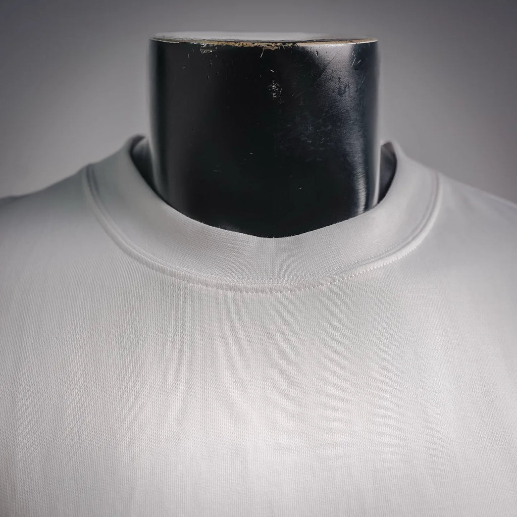 White crew-neck long-sleeve T-shirt close-up at collar