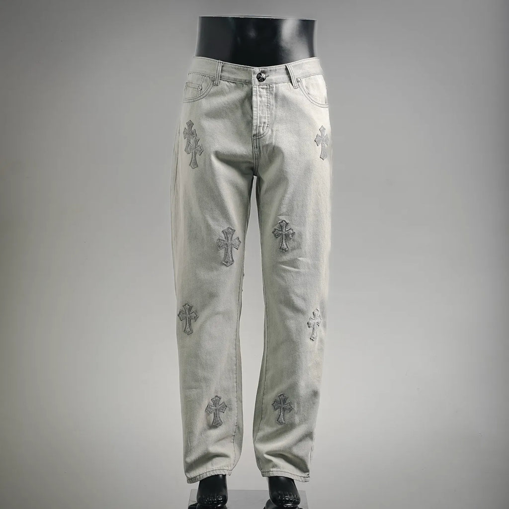 Light gray denim pants with cross-style embroidery, button-and-zip fly front
