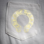 Close-up of white chest pocket with yellow circular logo print