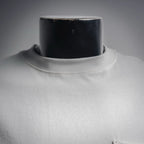 Close-up of white crew neckline on a long-sleeve T-shirt