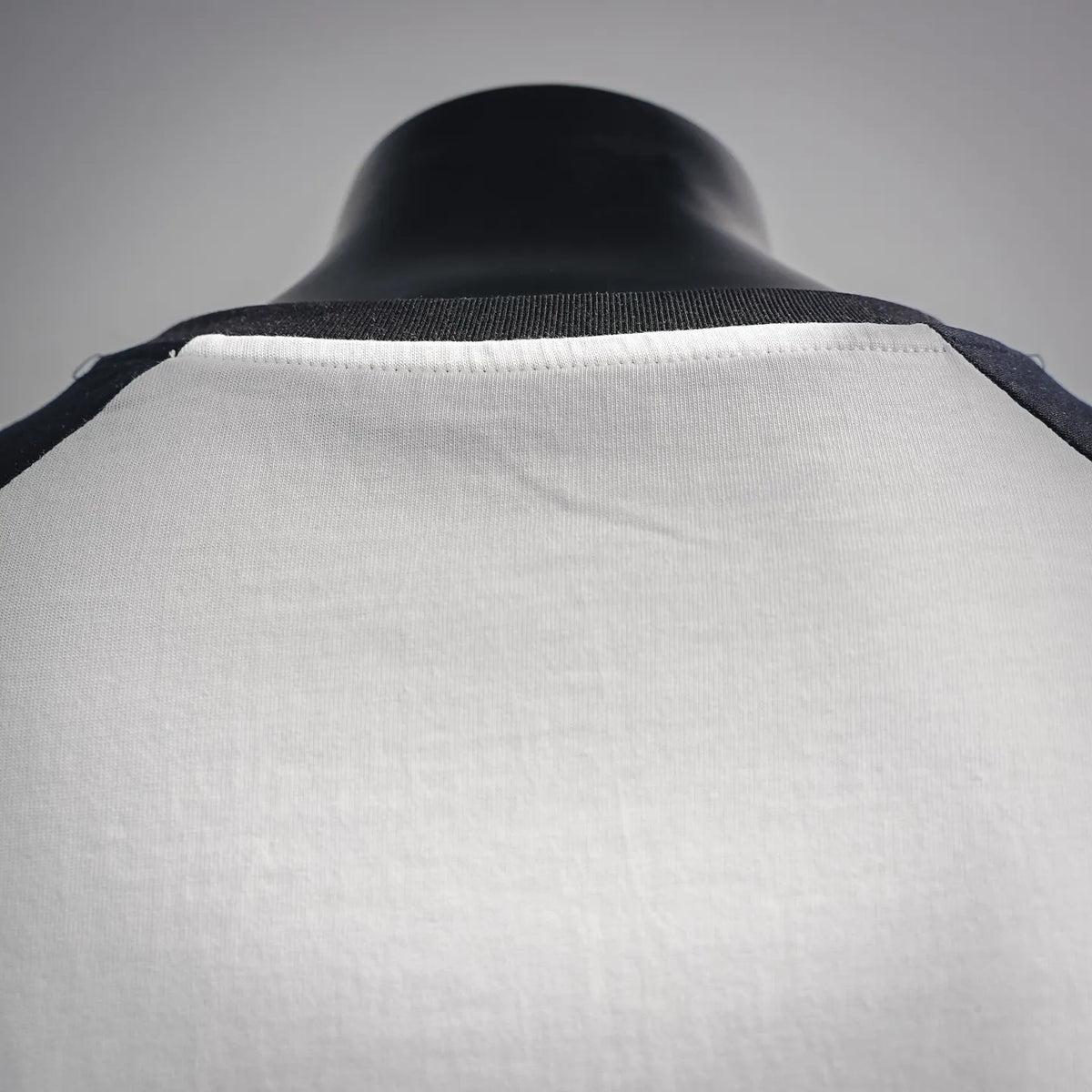 Back view of black-and-white raglan T-shirt with ribbed neckline
