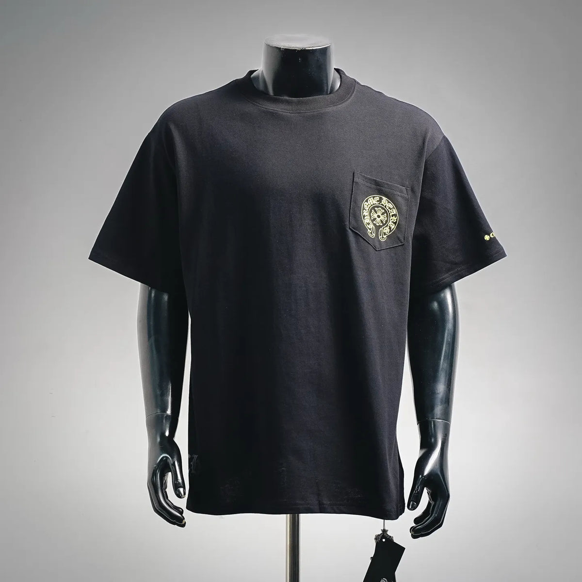 Black short-sleeve graphic T-shirt with small left-chest logo on a crew neck