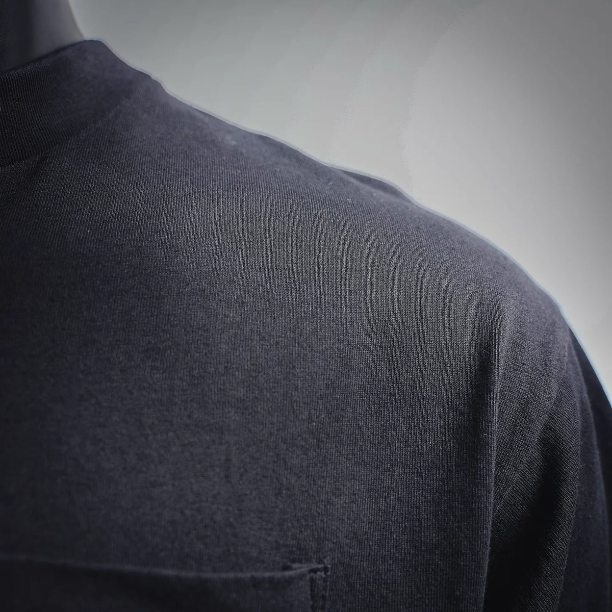 Black t-shirt fabric close-up from shoulder to back