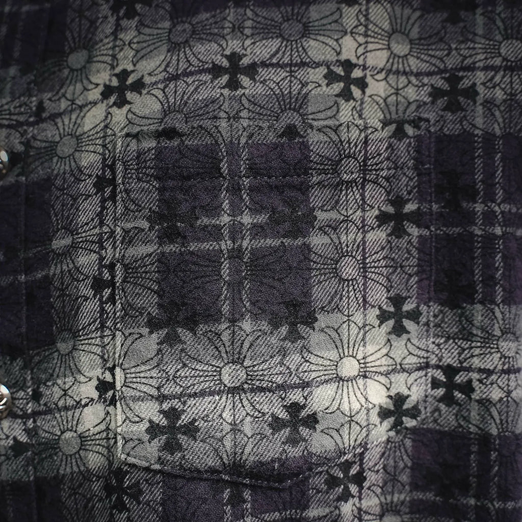 Close-up of dark plaid shirt with floral line pattern across the front