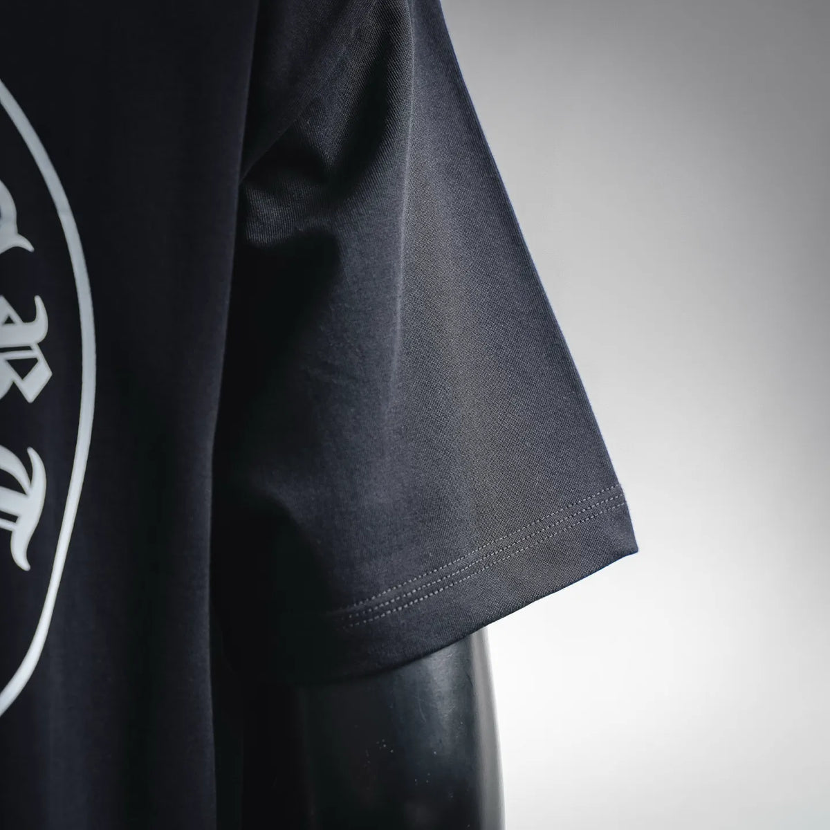 Black T-shirt sleeve and side seam detail