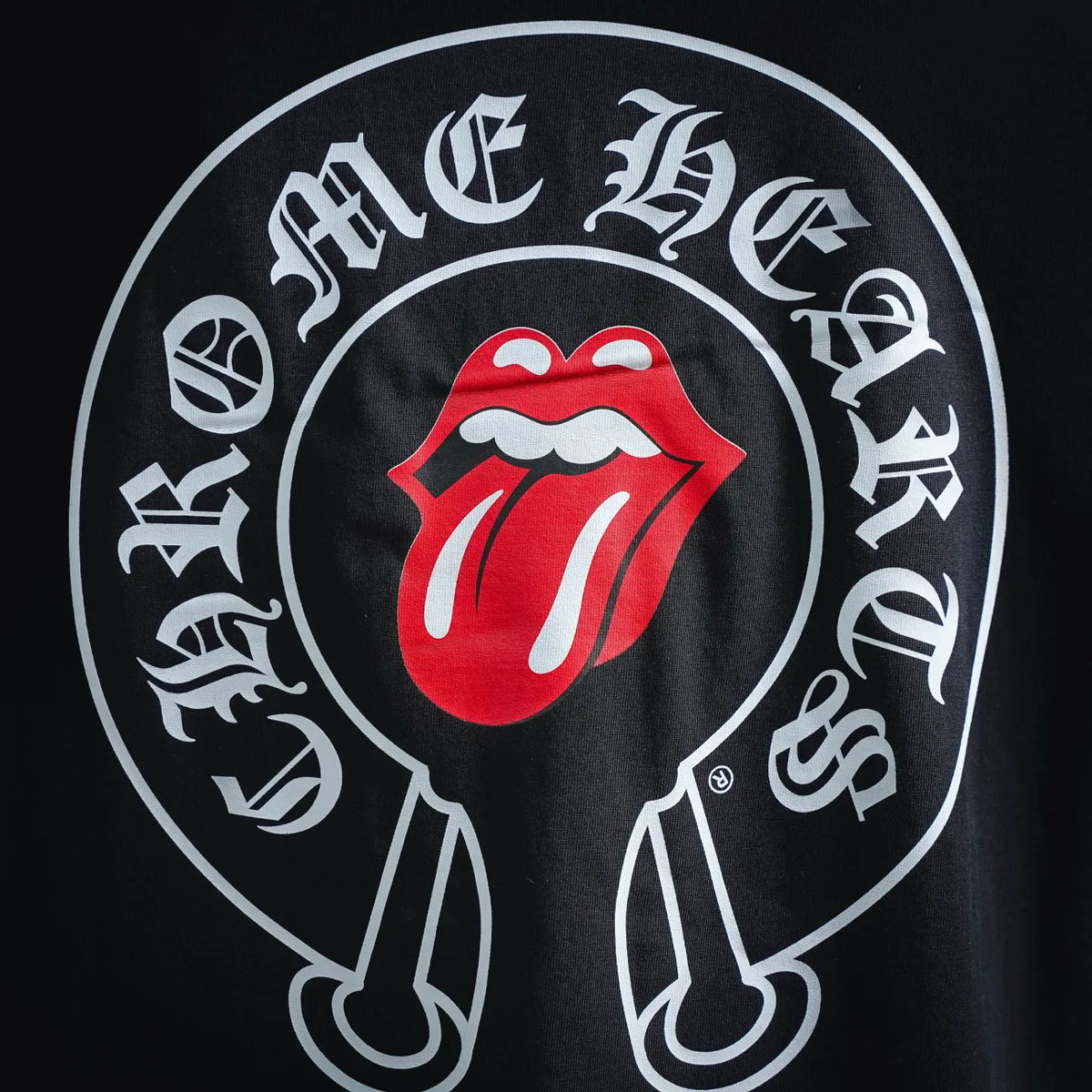 Close-up of black T-shirt circular tongue graphic in red and white