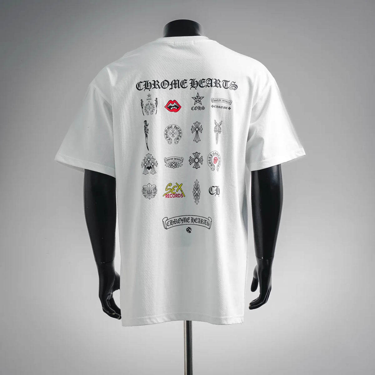 White back graphic T-shirt with multiple logo patches and text