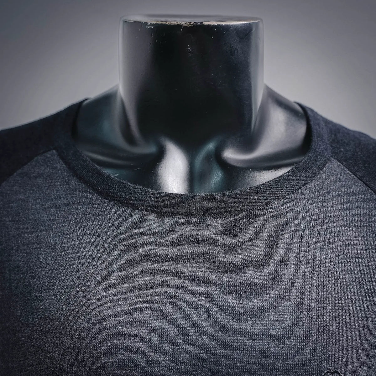 Crew neck front view of heather gray long-sleeve raglan T-shirt with neckline seam