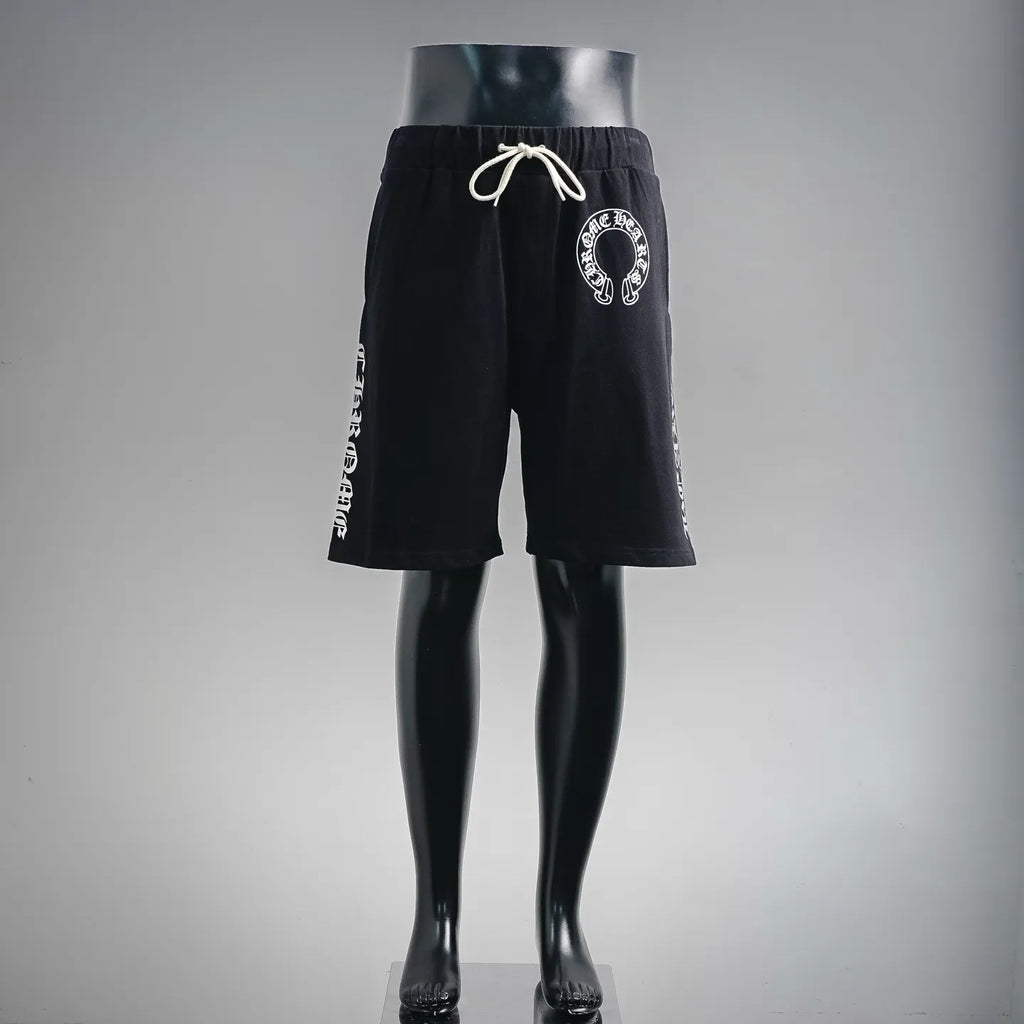Black drawstring shorts with elastic waistband and circular front logo patch