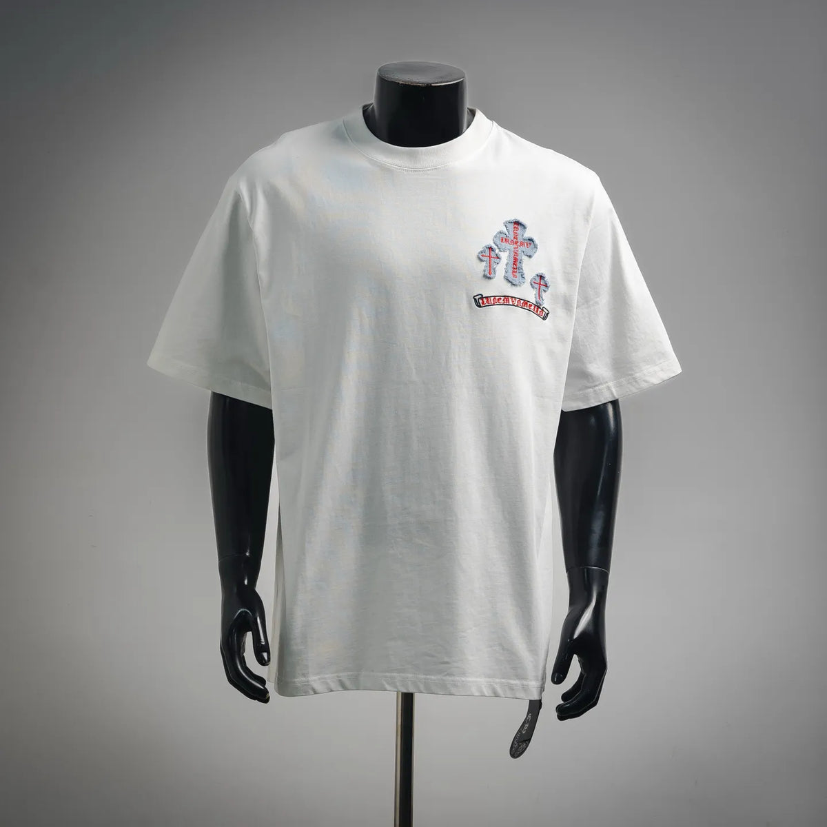 White short-sleeve crewneck T-shirt with colorful cross graphic on left chest