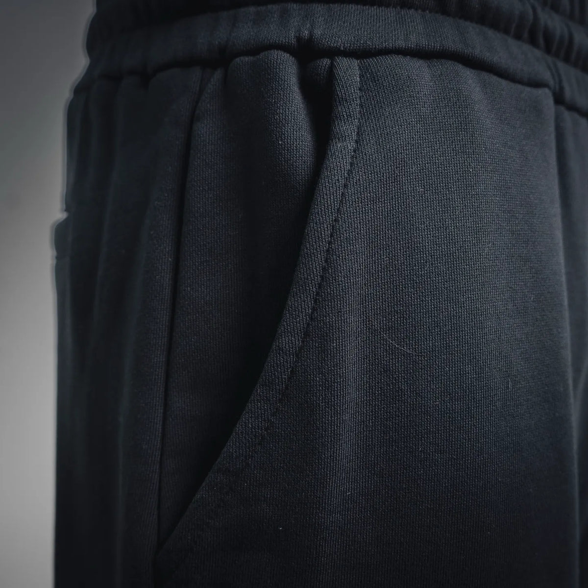 Dark shorts side panel seam with inner drape detail