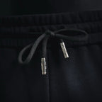 Dark drawstring shorts with silver-toned aglet tips