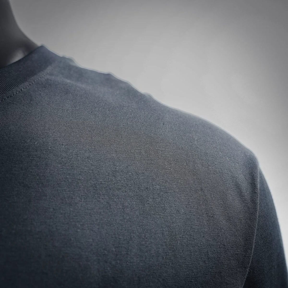 Dark T-shirt shoulder fabric texture close-up
