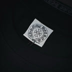 Dark long-sleeve shirt neckline with sewn white brand label patch