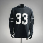 Black long-sleeve graphic T-shirt with large white "33" print and striped sleeve detail
