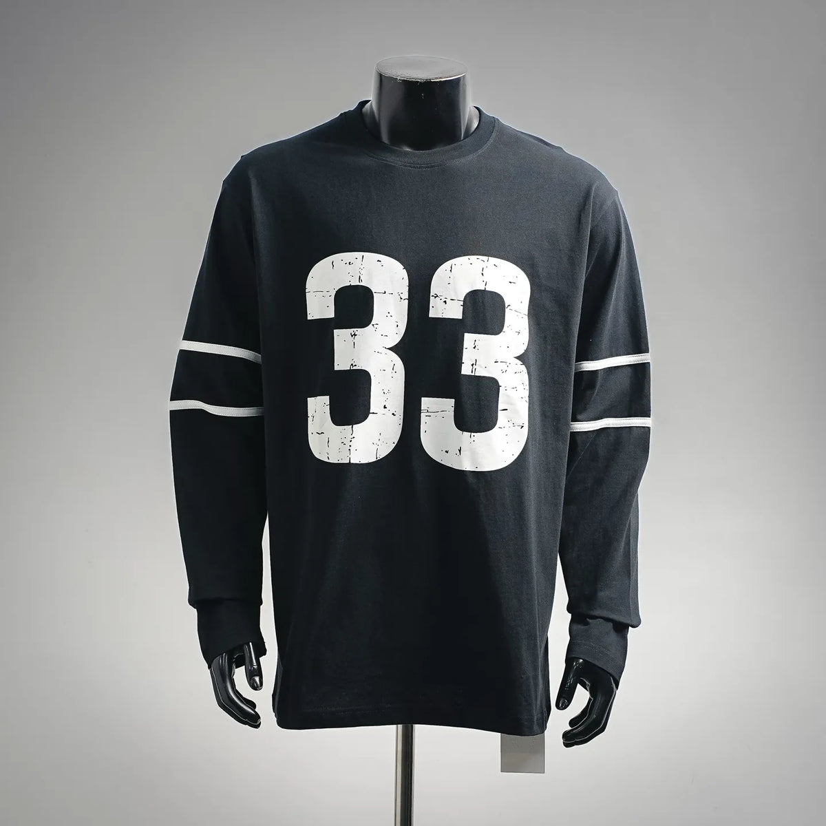 Black long-sleeve graphic T-shirt with large white "33" print and striped sleeve detail