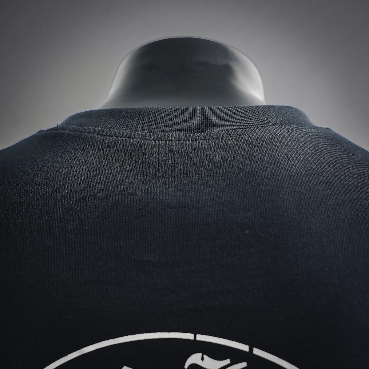Black long-sleeve T-shirt close-up of ribbed crew neckline and fabric texture
