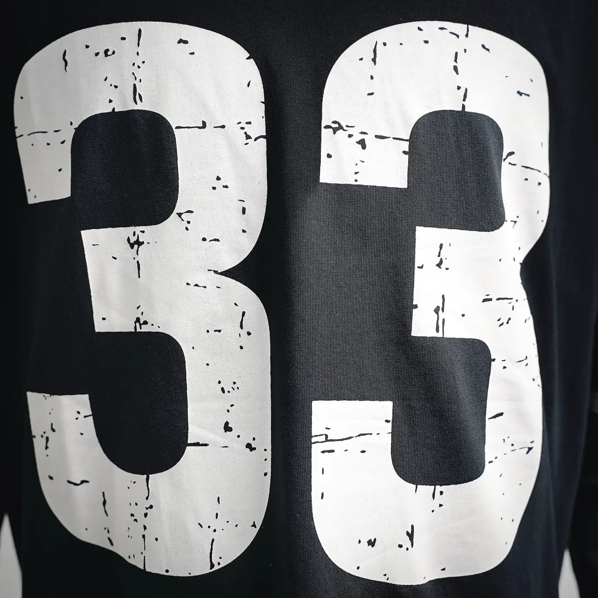 Black long-sleeve T-shirt with oversized distressed white "33" number print