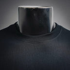 Black long-sleeve T-shirt close-up of crew neck collar on mannequin