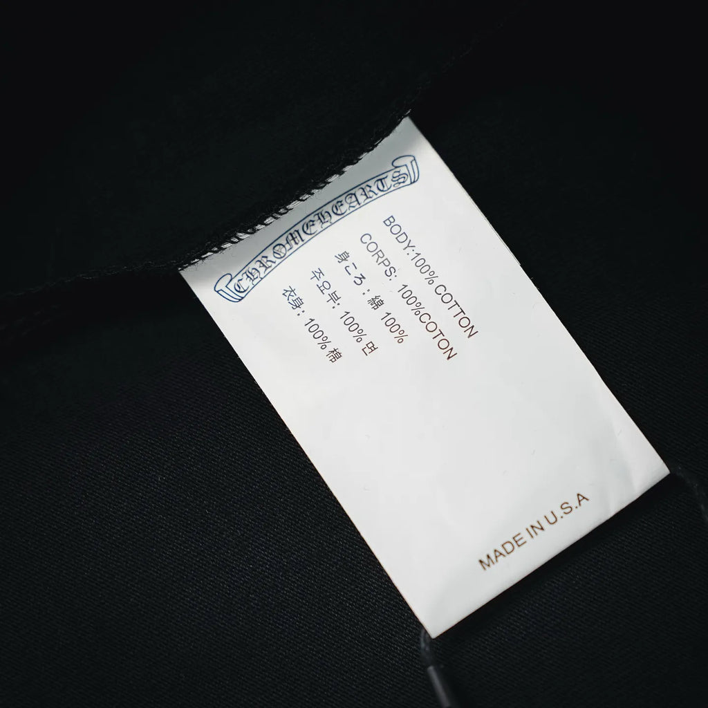 Black long-sleeve T-shirt label showing cotton content and "Made in U.S.A"