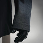Black long-sleeve T-shirt sleeve cuff close-up with stitched hem