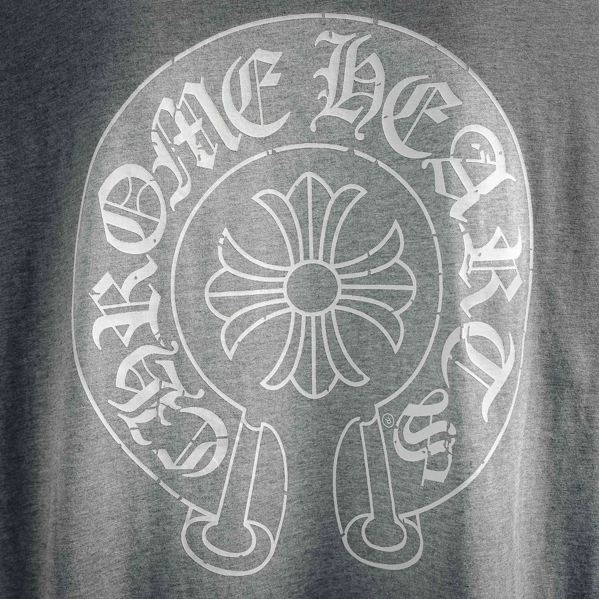 Close-up of circular back graphic logo on heather gray long-sleeve T-shirt
