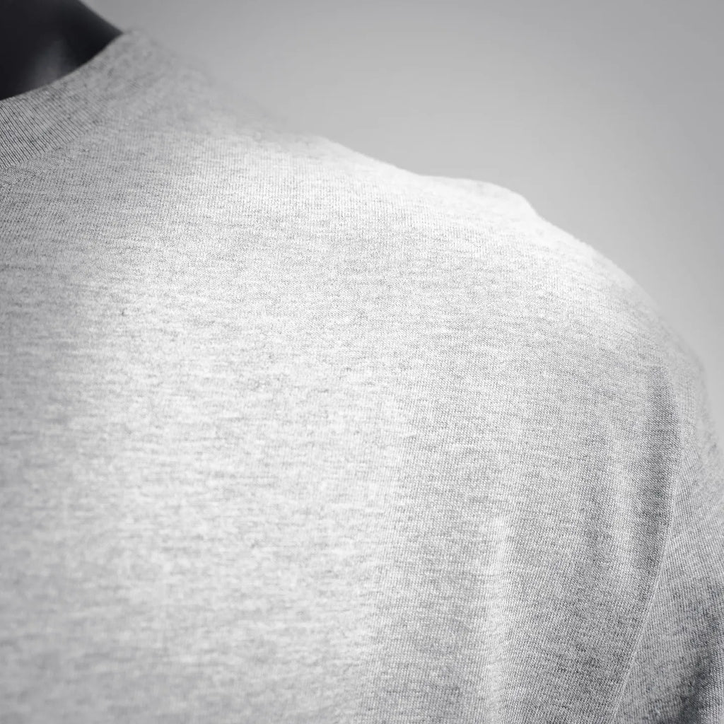 Heather gray long-sleeve T-shirt fabric close-up, crewneck shoulder area