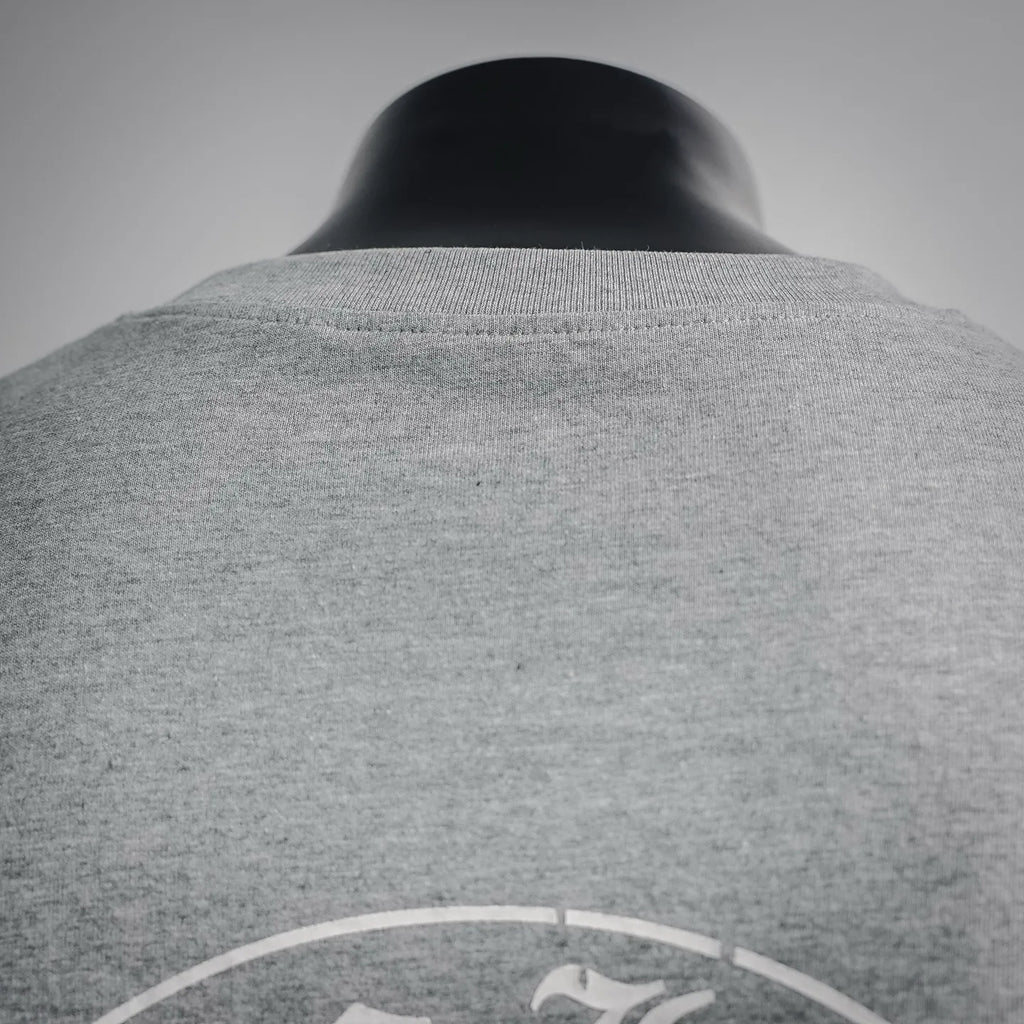 Heather gray long-sleeve T-shirt back view with circular logo near upper back