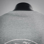 Heather gray long-sleeve T-shirt back view with circular logo near upper back